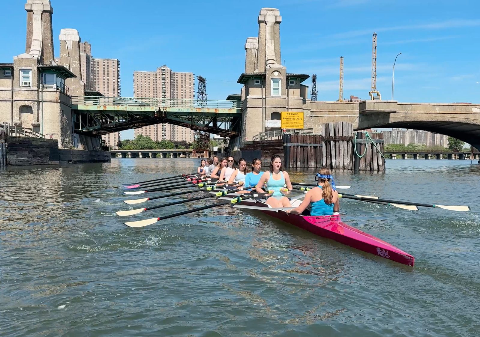 The pink eight passing under the bridge towers
