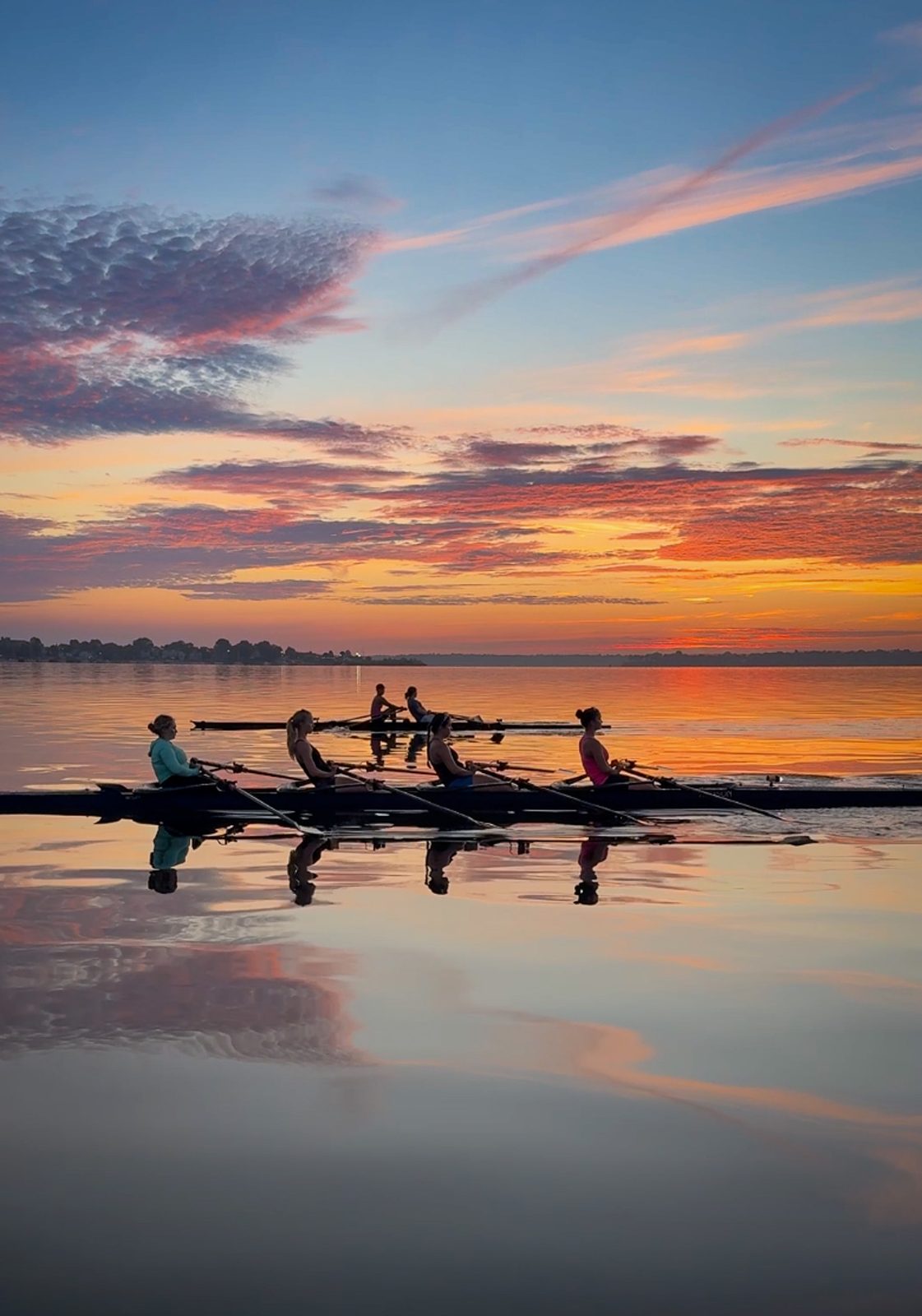 A quad and its perfect reflection under pink dawn clouds