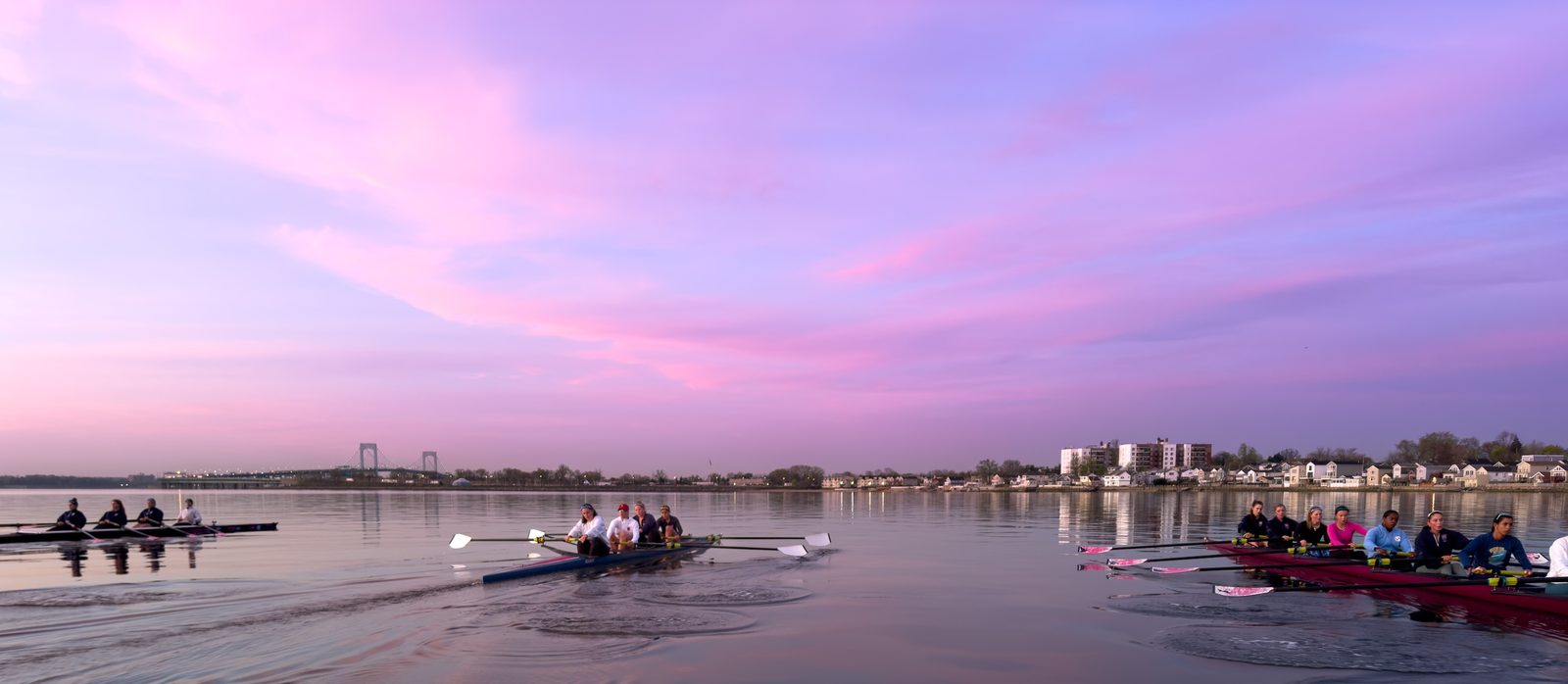 Boats out under a cotton-candy pink sky