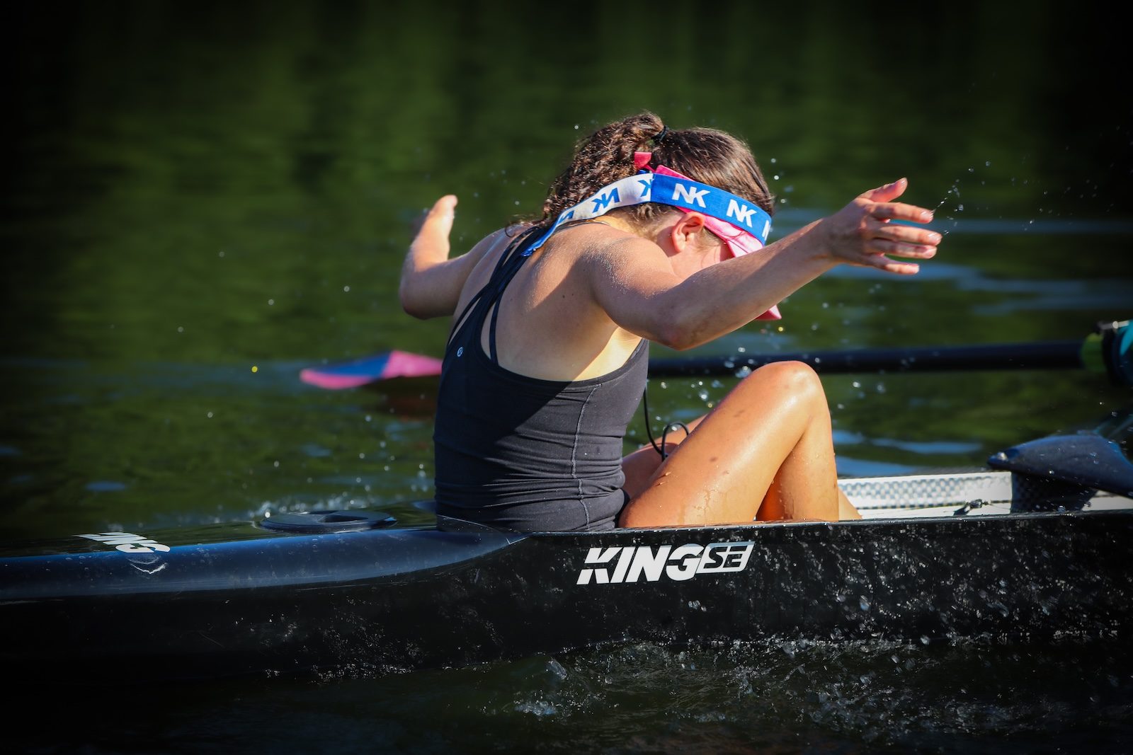 A sculler celebrating with a splash